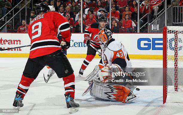 Zach Parise and Andy Greene of the New Jersey Devils watch a shot from teammate Patrik Elias , get by Martin Biron of the New York Islanders for a...