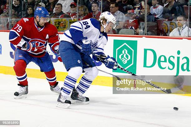 Mikhail Grabovski of the Toronto Maple Leafs stick handles the puck while being defended by Andrei Markov of the Montreal Canadiens during the NHL...