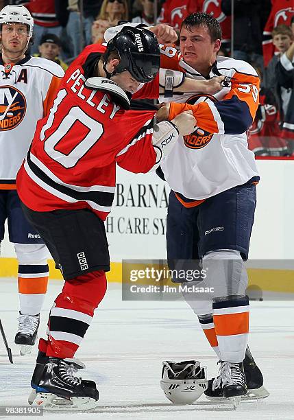 Rod Pelley of the New Jersey Devils trades punches with Michael Haley of the New York Islanders during their second period fight at the Prudential...