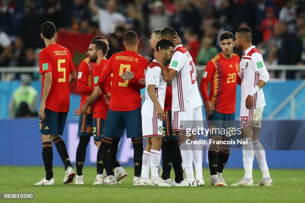 Aziz Bouhaddouz of Morocco consoles teammate Mbark Boussoufa of Morocco after the 2018 FIFA World Cup Russia group B match between Spain and Morocco...