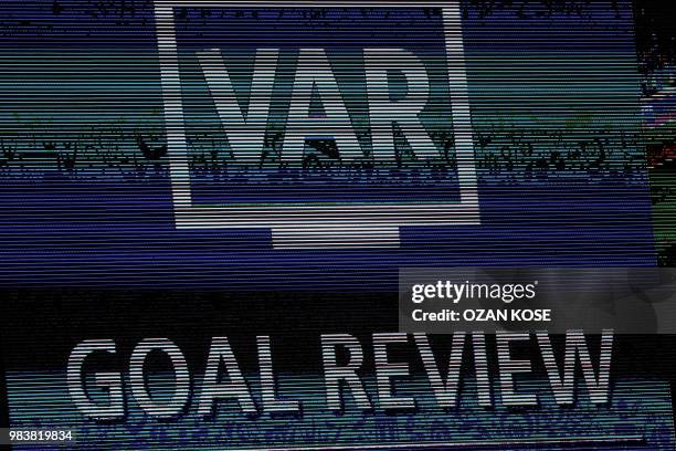 Screen displays the VAR goal review confirming Spain's second goal during the Russia 2018 World Cup Group B football match between Spain and Morocco...