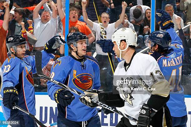 Bill Guerin of the Pittsburgh Penguins skates away as Bryan Little of the Atlanta Thrashers celebrates his goal with Slava Kozlov and Clarke...