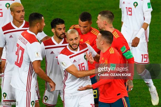 Morocco's forward Noureddine Amrabat reacts as players clash during the Russia 2018 World Cup Group B football match between Spain and Morocco at the...