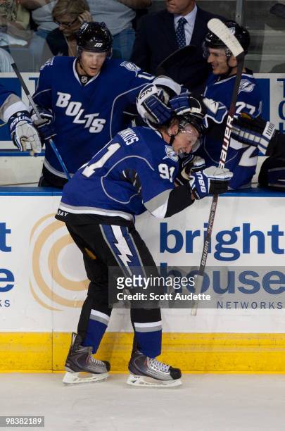 Steven Stamkos of the Tampa Bay Lightning celebrates his 50th goal of the season with teammates along the bench in the second period against the...