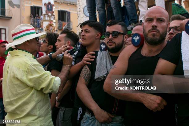 Teammates called portatori carry the "Gigli", an 25 metre high wooden obelisk weighing 3 tonnes carry by 160 persone along the streets of the small...