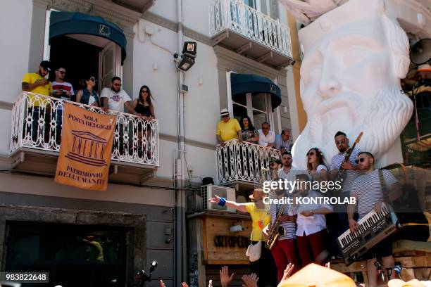 Musicians sIng and play on 25 metre high wooden obelisk called "Gigli" weighing 3 tonnes carry by 160 people along the streets of the small city of...