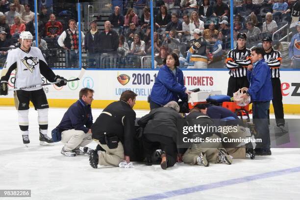 Matt Cooke of the Pittsburgh Penguins is attended to by paramedics after his fight against Evander Kane of the Atlanta Thrashers at Philips Arena on...