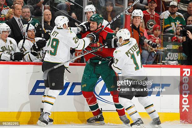 Steve Ott and Toby Petersen of the Dallas Stars fight with Derek Boogaard of the Minnesota Wild during the game at the Xcel Energy Center on April...