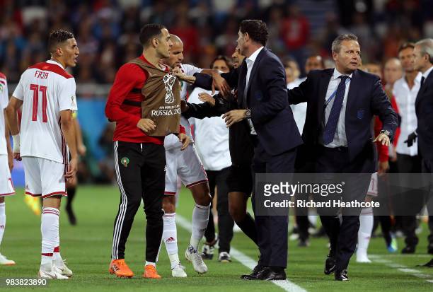 Faycal Fajr of Morocco confronts Fernando Hierro, Head coach of Spain after a VAR review leads to a goal by Iago Aspas of Spain being awarded during...
