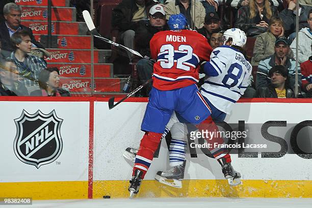 Travis Moen of Montreal Canadiens collides with Mikhail Grabovski of the Toronto Maple Leafs during the NHL game on April 10, 2010 at the Bell Center...