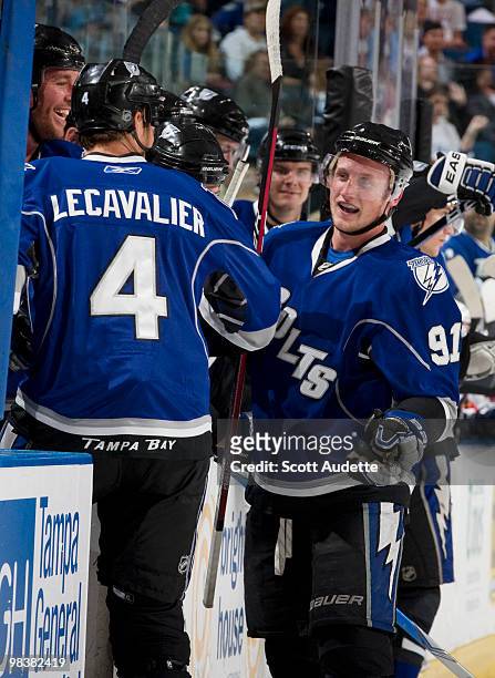 Steven Stamkos of the Tampa Bay Lightning celebrates his 50th goal with teammate Vincent Lecavalier along the bench in the second period against the...