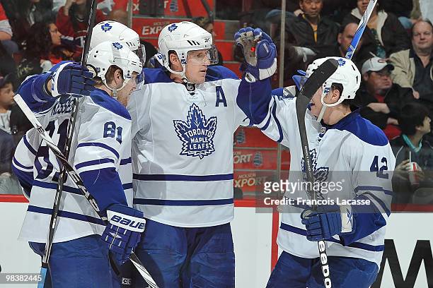 Dion Phaneuf of the Toronto Maple Leafs celebrates a goal with teammate Tyler Bozak and Phil Kessel during the NHL game against the Montreal...