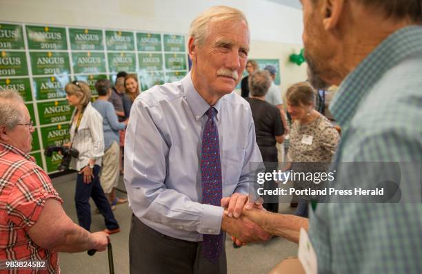 Senator Angus King shakes hands and talks momentarily with Jim Johnston of Cape Elizabeth after a rally to kick off his re-election campaign at the...