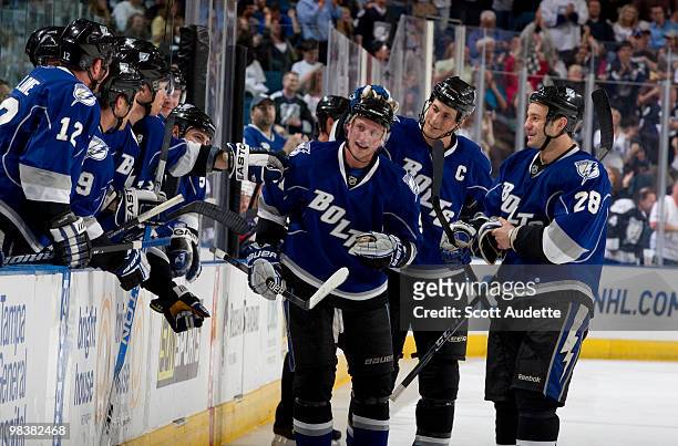 Steven Stamkos of the Tampa Bay Lightning celebrates his 50th goal of the season with teammates along the bench against the Florida Panthers in the...
