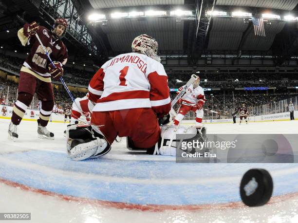 Scott Gudmanson of the Wisconsin Badgers is unable to stop a shot by Ben Smith of the Boston College Eagles on April 10, 2010 during the championship...