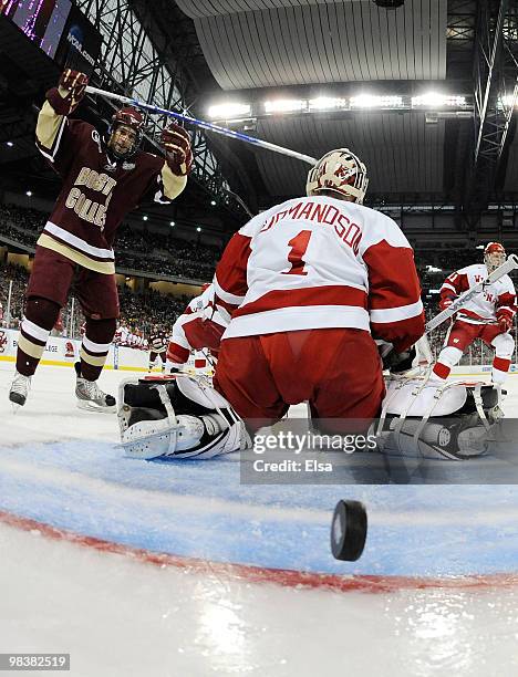 Brian Gibbons of the Boston College Eagles celebrates Ben Smith's goal in the first period as Scott Gudmandson of the Wisconsin Badgers stands by on...