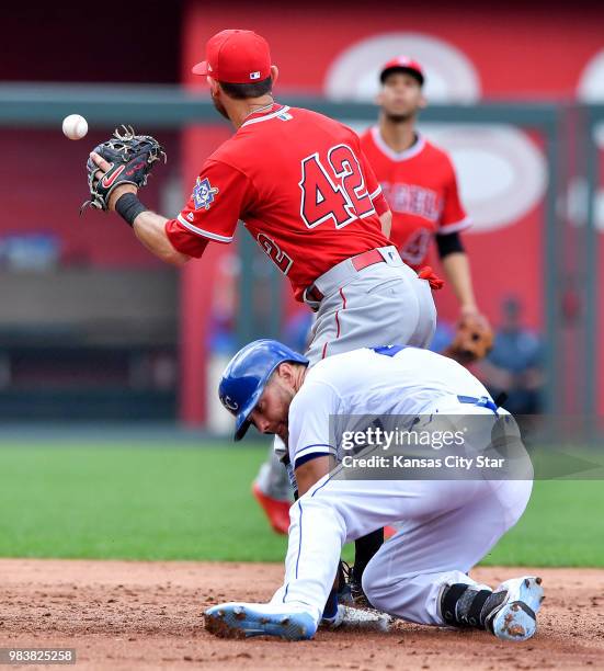 Kansas City Royals' Alex Gordon reaches second before the throw to Los Angeles Angels second baseman Ian Kinsler on a double in the second inning...