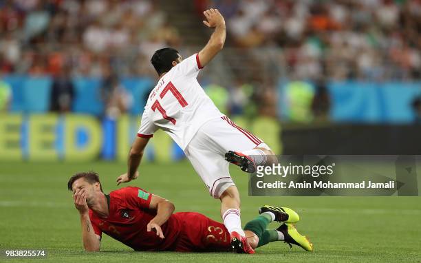 Adrien Silva of Portugal and Mehdi Taremi of Iran in action during the 2018 FIFA World Cup Russia group B match between Iran and Portugal at Mordovia...