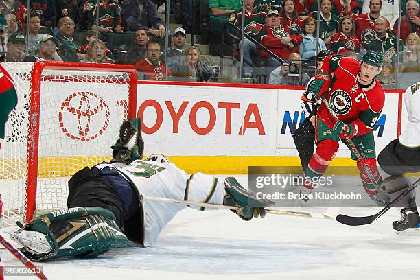 Mikko Koivu of the Minnesota Wild scores a goal against Kari Lehtonen of the Dallas Stars during the game at the Xcel Energy Center on April 10, 2010...