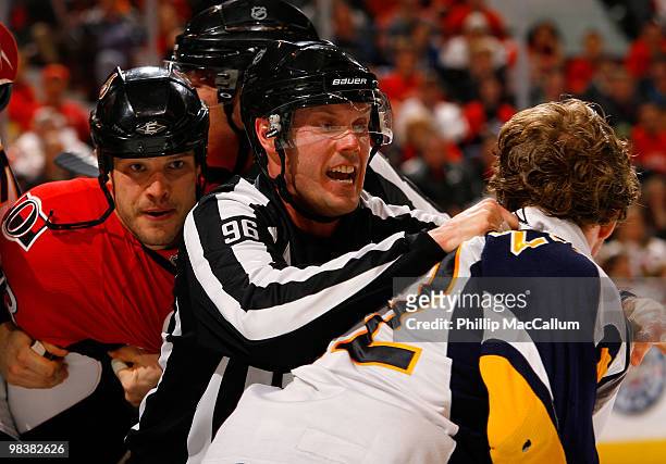 Linesman David Brisebois gets in between Jarkko Ruutu of the Ottawa Senators and Adam Mair of the Buffalo Sabres while trying to break up a fight in...