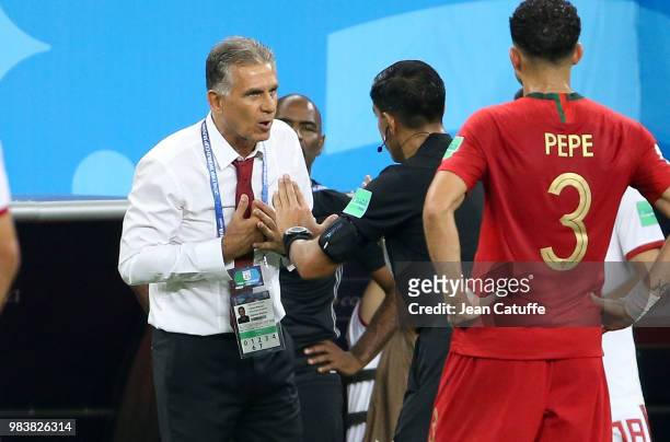 Referee Enrique Caceres of Paraguay calms down coach of Iran Carlos Queiroz during the 2018 FIFA World Cup Russia group B match between Iran and...