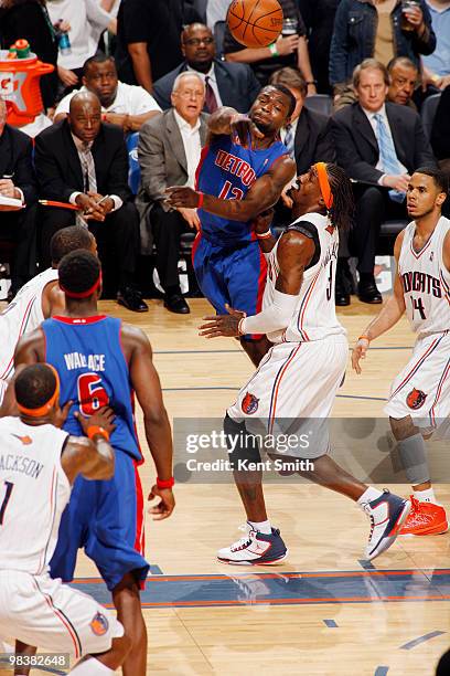 Will Bynum of the Detroit Pistons makes the pass around Gerald Wallace of the Charlotte Bobcats on April 10, 2010 at the Time Warner Cable Arena in...