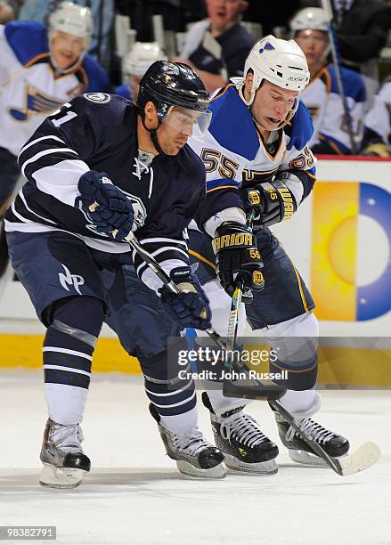 Francis Bouillon of the Nashville Predators ties up the stick of Cam Janssen of the St. Louis Blues on April 10, 2010 at the Bridgestone Arena in...