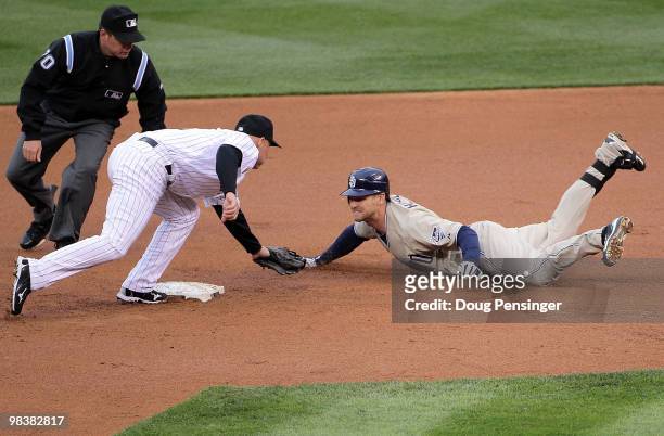 Third baseman Chase Headley of the San Diego Padres is tagged out at second base by second baseman Clint Barmes of the Colorado Rockies while trying...