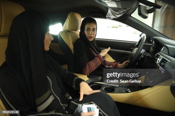 Modia Batterjee asks questions to saleswoman Haifa Alsehli while they sit in a Lexus car Modia is interested in buying at a Lexus dealership the day...