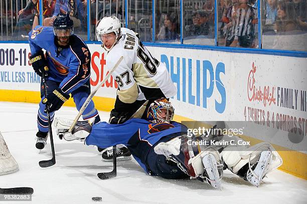 Johnny Oduya defends as goaltender Johan Hedberg of the Atlanta Thrashers falls to the ice after getting tripped up by Sidney Crosby of the...