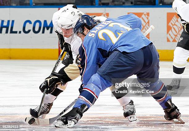 Sidney Crosby of the Pittsburgh Penguins faces off against Jim Slater of the Atlanta Thrashers at Philips Arena on April 10, 2010 in Atlanta, Georgia.