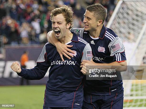 Zack Schilawski of the New England Revolution celebrates the first of three goals with teammate Chris Tierney in the second half against the Toronto...