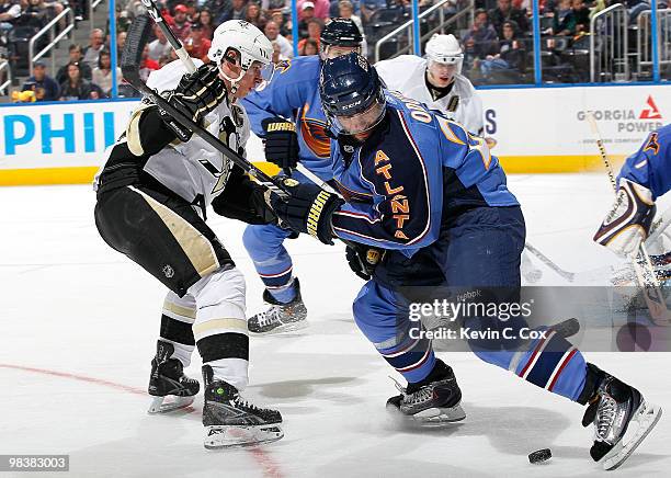 Sidney Crosby of the Pittsburgh Penguins skates into Johnny Oduya of the Atlanta Thrashers at Philips Arena on April 10, 2010 in Atlanta, Georgia.