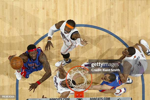 Ben Wallace of the Detroit Pistons blocks against Gerald Wallace of the Charlotte Bobcats on April 10, 2010 at the Time Warner Cable Arena in...