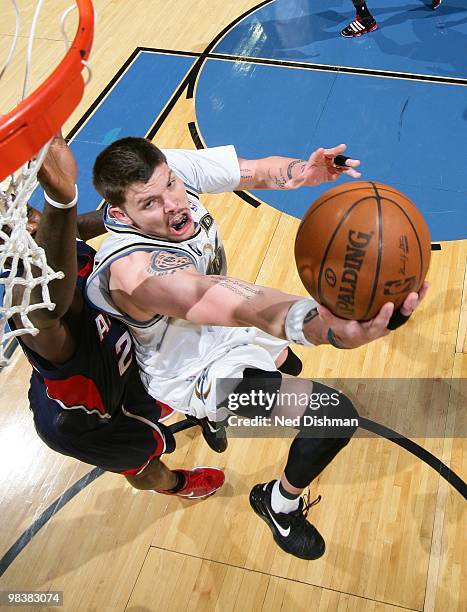 Mike Miller of the Washington Wizards shoots against Marvin Williams of the Atlanta Hawks at the Verizon Center on April 10, 2010 in Washington, DC....