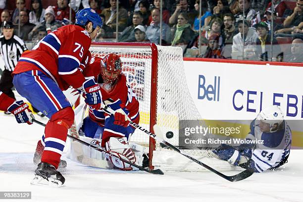 Jaroslav Halak of the Montreal Canadiens stops the puck on a wrap around attempyt by Mikhail Grabovski of the Toronto Maple Leafs during the NHL game...