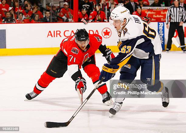 Tyler Ennis of the Buffalo Sabres takes a wrist shot from the circle with Nick Foligno of the Ottawa Senators trying to defend against him in a game...