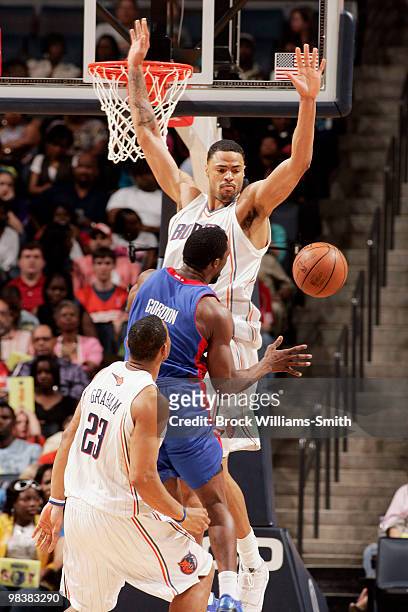 Tyson Chandler of the Charlotte Bobcats blocks against Ben Gordon of the Detroit Pistons on April 10, 2010 at the Time Warner Cable Arena in...