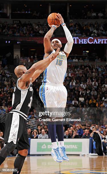 Carmelo Anthony of the Denver Nuggets goes to the basket against Keith Bogans of the San Antonio Spurs on April 10, 2010 at the Pepsi Center in...