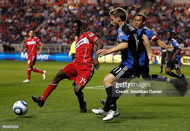 Patrick Nyarko of Chicago Fire passes the ball under pressure from Bobby Convey and Ramiro Corrales of San Jose Earthquakes in an MLS match on April...