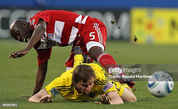 Midfielder Jair Benitez of FC Dallas falls on top of Eddie Gaven of the Columbus Crew at Pizza Hut Park on April 10, 2010 in Frisco, Texas.