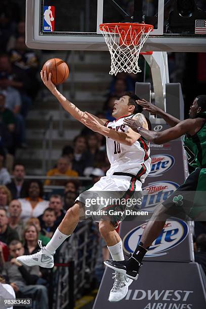 Carlos Delfino of the Milwaukee Bucks shoots a layup against Michael Finley of the Boston Celtics on April 10, 2010 at the Bradley Center in...