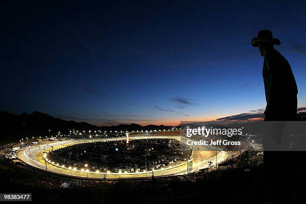 Fan watches as cars race during the NASCAR Sprint Cup Series SUBWAY Fresh Fit 600 at Phoenix International Raceway on April 10, 2010 in Phoenix,...