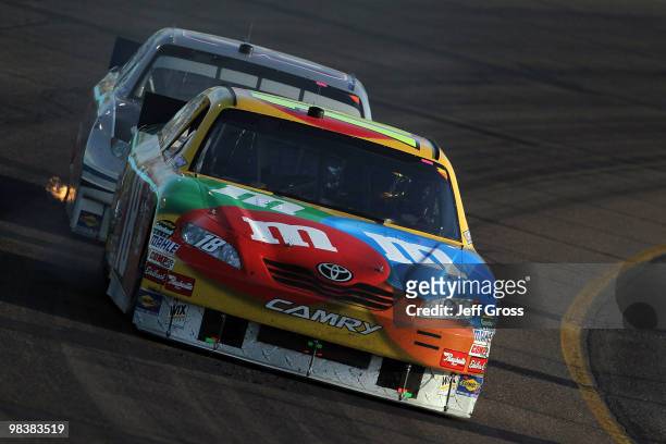 Kyle Busch, driver of the M&M's Toyota, drives during the NASCAR Sprint Cup Series SUBWAY Fresh Fit 600 at Phoenix International Raceway on April 10,...