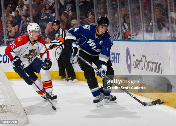 Vincent Lecavalier of the Tampa Bay Lightning controls the puck against Rostislav Olesz of the Florida Panthers at the St. Pete Times Forum on April...