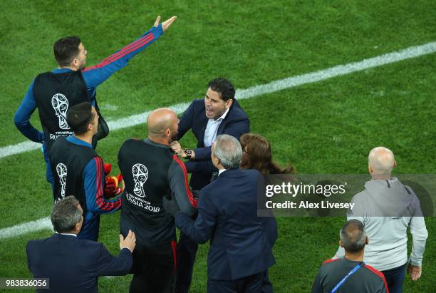 Fernando Hierro, Head coach of Spain restrains Pepe Reina of Spain following arguement between both benches following a VAR decision during the 2018...