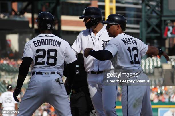Nicholas Castellanos of the Detroit Tigers celebrates his three run seventh inning home run with Leonys Martin and Niko Goodrum while playing the...