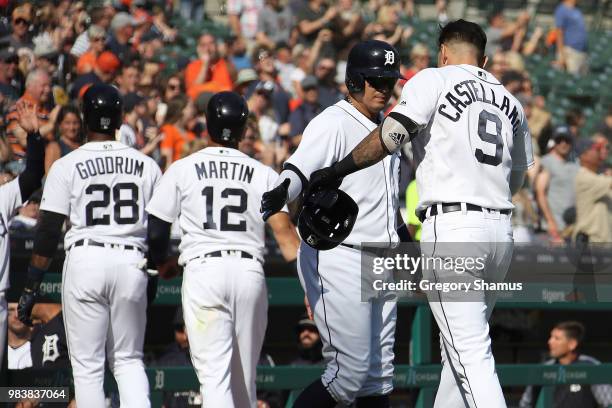 Nicholas Castellanos of the Detroit Tigers celebrates his three run seventh inning home run with Victor Martinez while playing the Oakland Athletics...