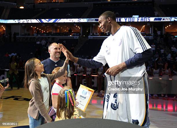 Hasheem Thabeet of the Memphis Grizzlies high-fives a fan after a game against the Philadelphia 76ers on April 10, 2010 at FedExForum in Memphis,...