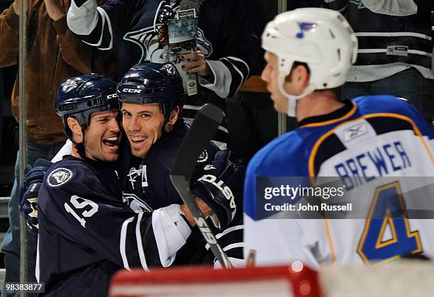 Eric Brewer of St. Louis Blues skates by Jason Arnott and Shea Weber of the Nashville Predators as they celebrate Arnotts goal against the Blues on...